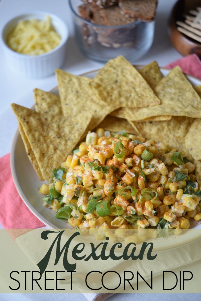 This Mexican Street Corn Dip is a delicious appetizer that is served with tortilla chips.