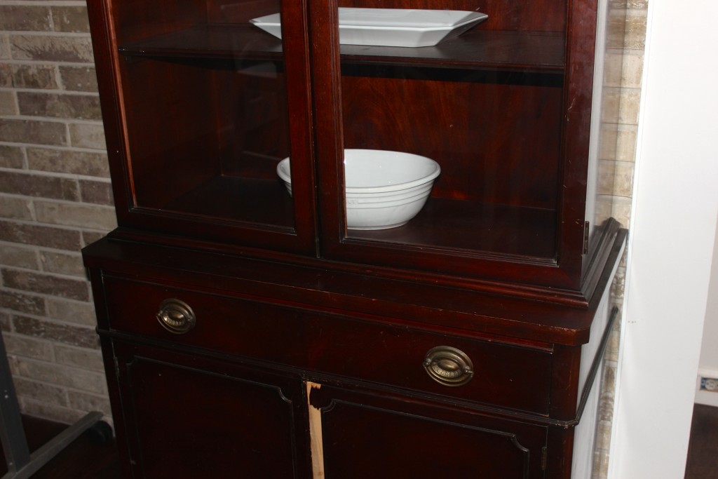 The only major issue was a that piece that had broken off on the bottom cabinet. I actually had the broken piece of wood so I could repair it, but it was lost in the move. Covering the cabinet with paint solved this problem!
