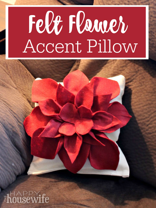 This felt flower accent pillow is easy to make in just about an hour. There are only a few supplies to gather and no sewing required. 100 Days of Homemade Christmas Gifts at The Happy Housewife