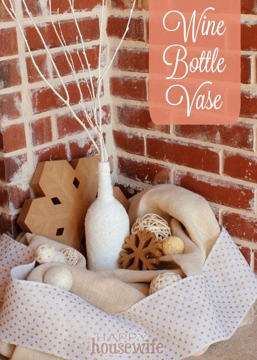 This snowy wine bottle vase craft is an easy and inexpensive way to add a beautiful touch of winter to any mantle, centerpiece, or just about any place you need a vase.
